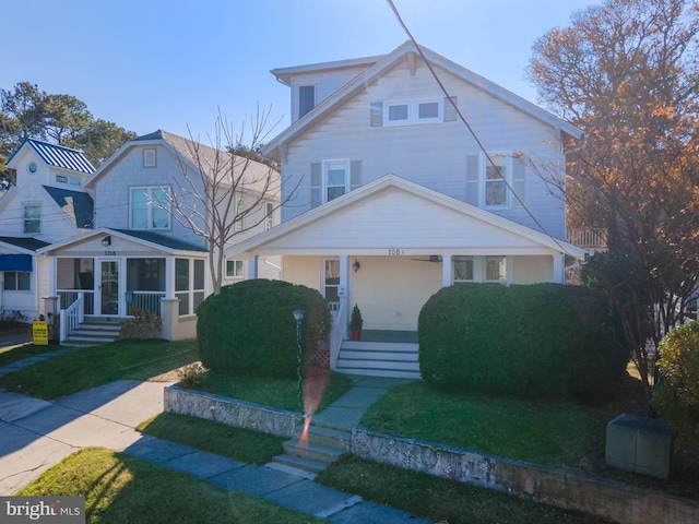 view of front facade with covered porch and a front yard