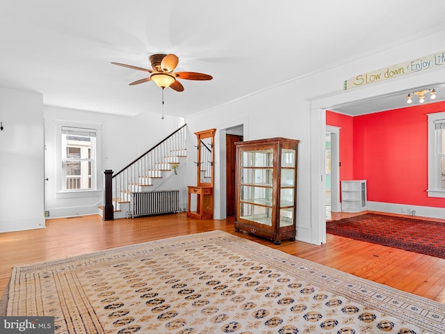 unfurnished living room featuring hardwood / wood-style flooring and ceiling fan