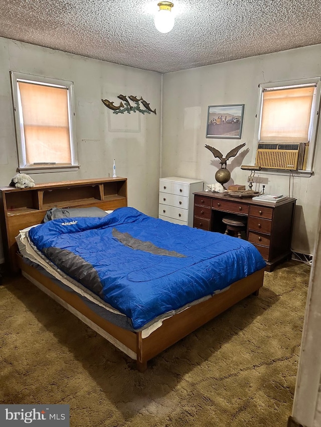 bedroom featuring a textured ceiling, carpet floors, multiple windows, and cooling unit