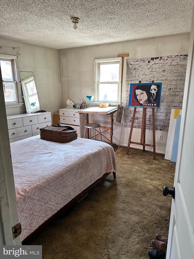 bedroom featuring a textured ceiling and carpet floors