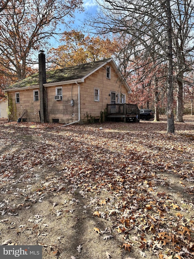 view of property exterior with a deck