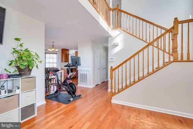 interior space featuring light wood-type flooring and an inviting chandelier