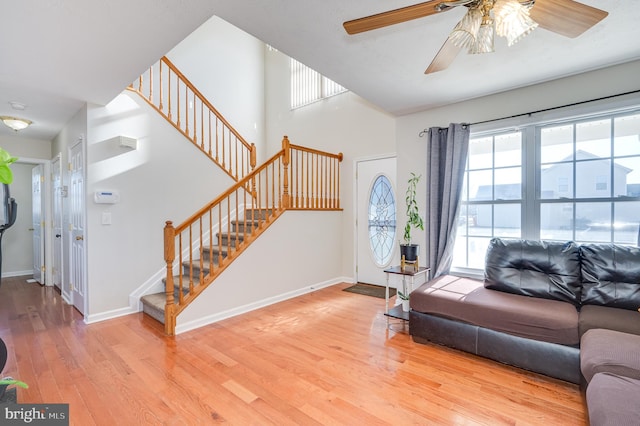 living room with ceiling fan and light wood-type flooring