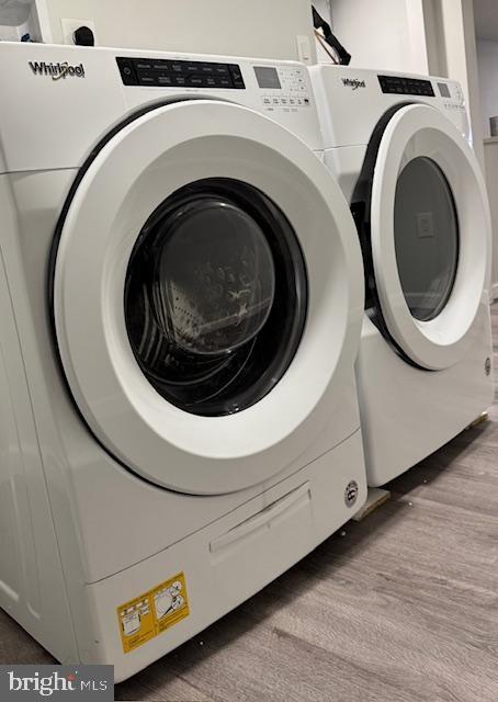 laundry area with light hardwood / wood-style flooring