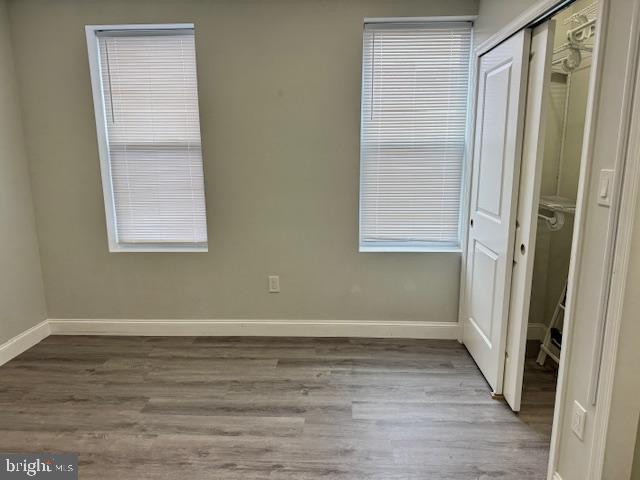 unfurnished bedroom with a closet and light hardwood / wood-style flooring