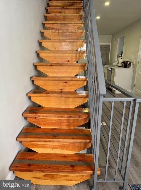 stairway featuring wood-type flooring