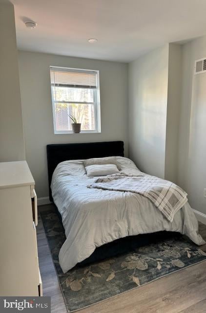 bedroom featuring dark hardwood / wood-style floors