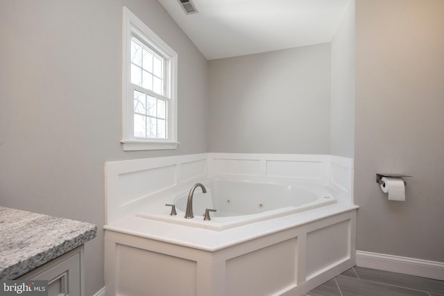 bathroom with a bath and wood-type flooring