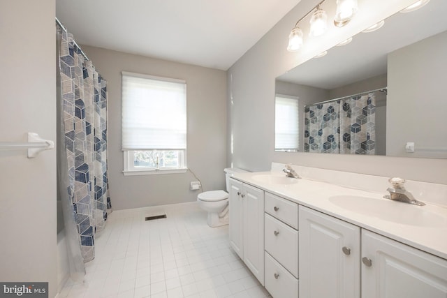 bathroom with tile patterned floors, vanity, and toilet