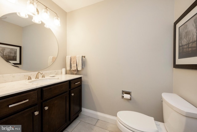 bathroom with tile patterned flooring, vanity, and toilet