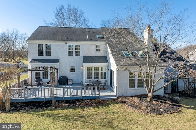 back of house featuring a yard and a wooden deck