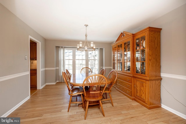 dining area featuring a chandelier and light hardwood / wood-style floors