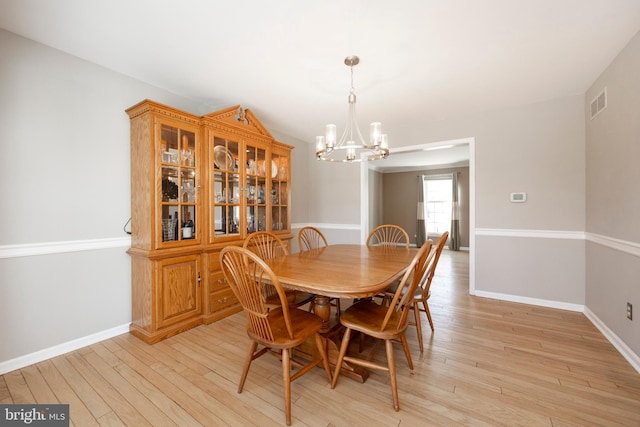 dining room featuring a notable chandelier and light hardwood / wood-style floors