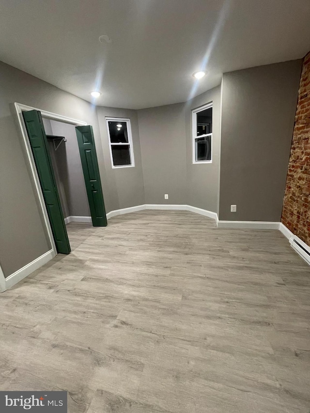 basement with light hardwood / wood-style floors