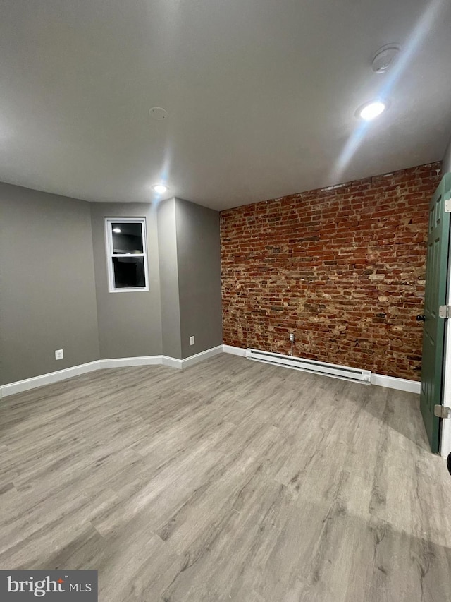 interior space with a baseboard radiator and light hardwood / wood-style flooring