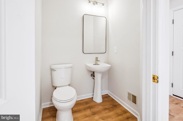 bathroom featuring sink, hardwood / wood-style floors, and toilet