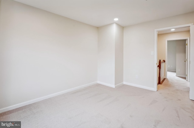 unfurnished room with light carpet