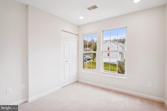 unfurnished room with light colored carpet