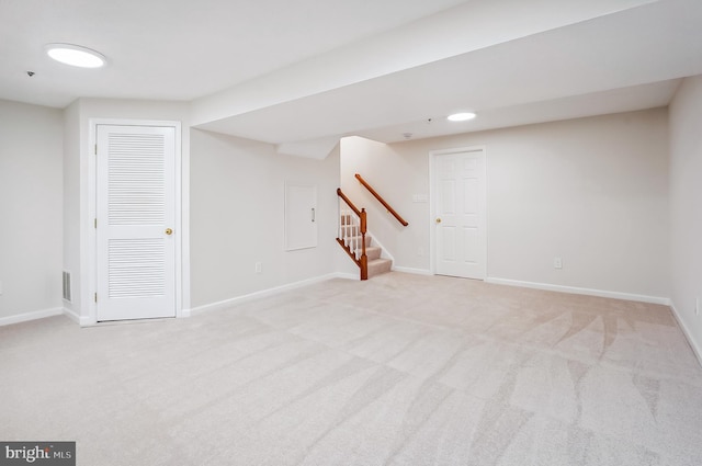 basement featuring light colored carpet