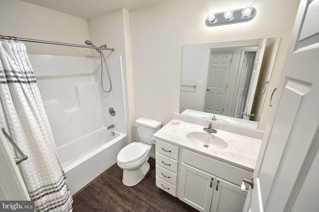 full bathroom featuring hardwood / wood-style floors, vanity, shower / bath combination with curtain, and toilet