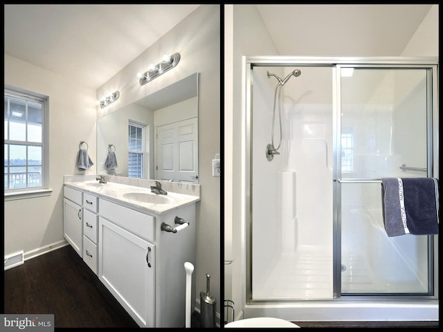 bathroom featuring hardwood / wood-style floors, vanity, and a shower with door