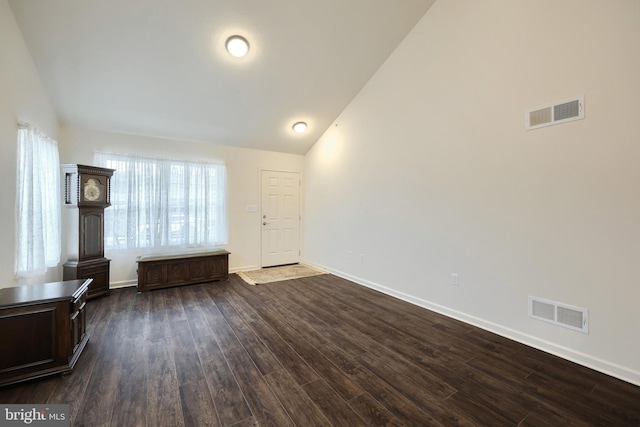 unfurnished living room with dark hardwood / wood-style flooring and high vaulted ceiling