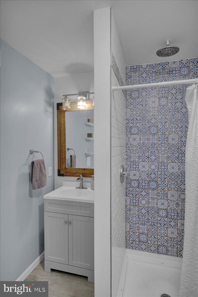 bathroom featuring vanity and tiled shower