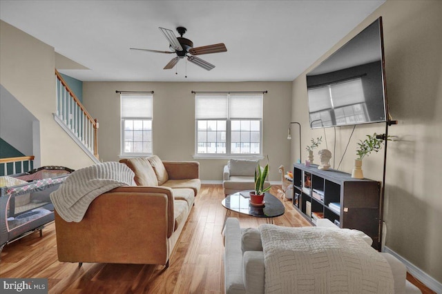 living room featuring hardwood / wood-style floors and ceiling fan