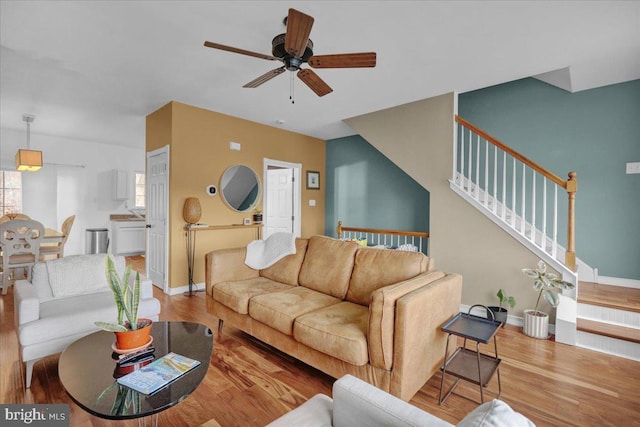 living room with ceiling fan and light hardwood / wood-style floors