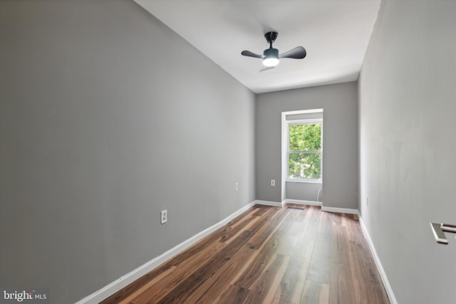 empty room with ceiling fan and dark wood-type flooring