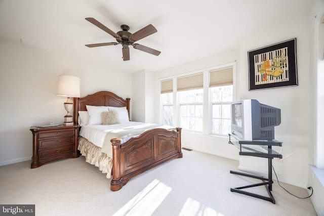 bedroom featuring ceiling fan and light carpet