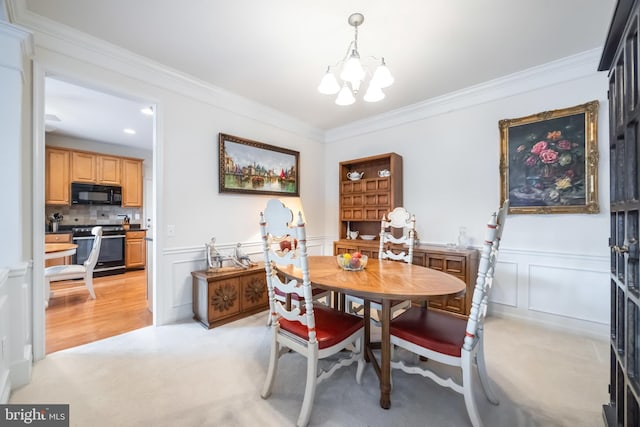 carpeted dining space featuring crown molding and a chandelier