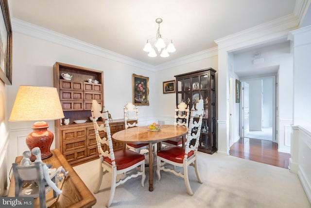 carpeted dining room featuring crown molding and an inviting chandelier