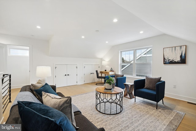 living room with light hardwood / wood-style flooring and lofted ceiling