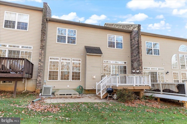 back of house with a lawn, central AC, a patio area, and a wooden deck