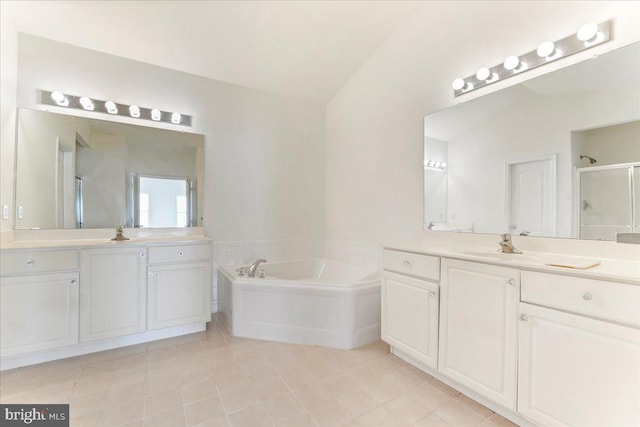 bathroom with shower with separate bathtub, vanity, and vaulted ceiling