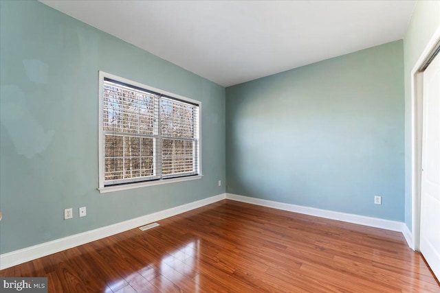 spare room featuring hardwood / wood-style floors