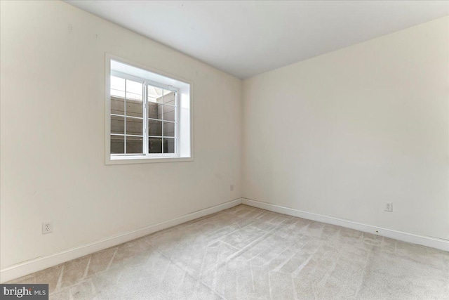 empty room featuring light carpet