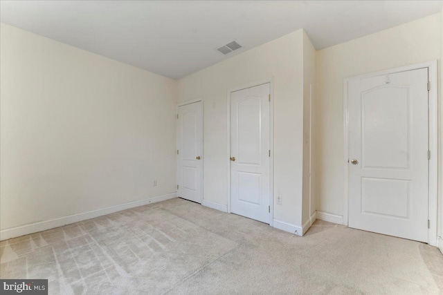 unfurnished bedroom with light colored carpet