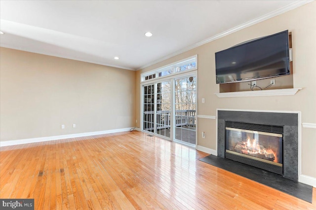 unfurnished living room featuring ornamental molding and hardwood / wood-style flooring