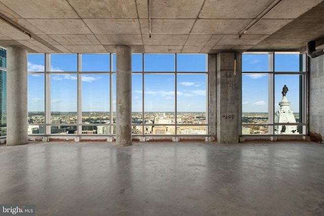 miscellaneous room featuring floor to ceiling windows, concrete flooring, and a wealth of natural light