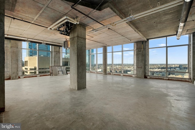 interior space featuring floor to ceiling windows and concrete floors