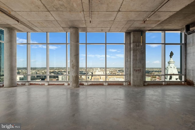 misc room with expansive windows, concrete flooring, and a wealth of natural light