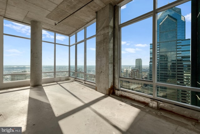 unfurnished sunroom with a healthy amount of sunlight and a water view