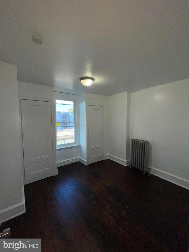 2014 Castor Ave, Philadelphia, PA 19134 - unfurnished room with radiator heating unit, dark wood-style flooring, and baseboards