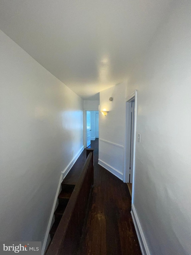 hall with dark hardwood / wood-style floors