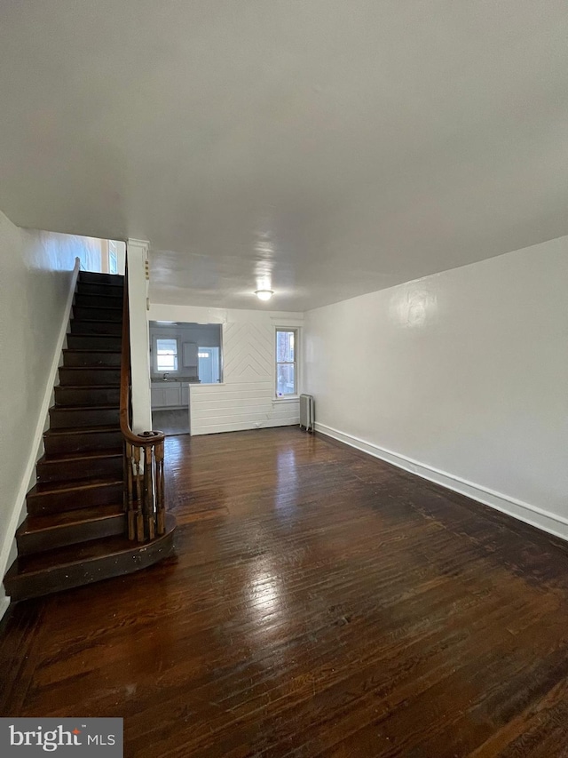 2014 Castor Ave, Philadelphia, PA 19134 - unfurnished living room with hardwood / wood-style floors, stairs, baseboards, and radiator heating unit