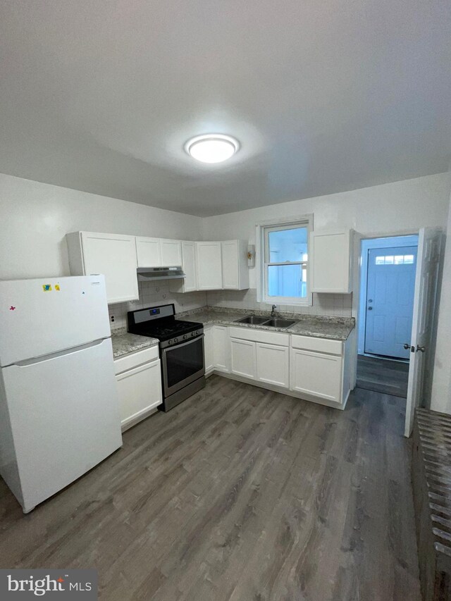 2014 Castor Ave, Philadelphia, PA 19134 - kitchen featuring freestanding refrigerator, stainless steel gas stove, under cabinet range hood, and white cabinets