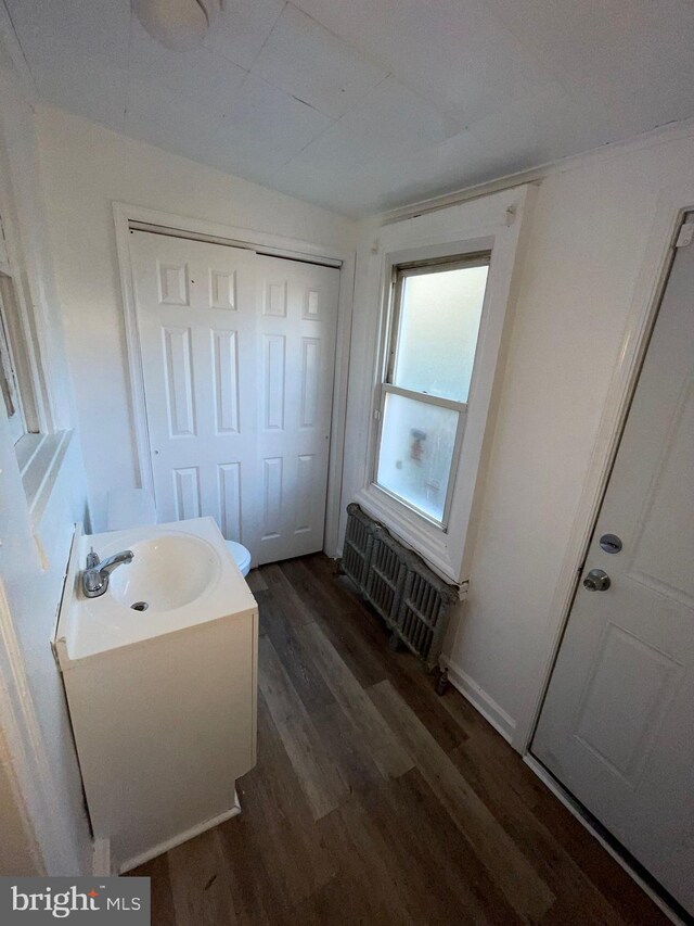 2014 Castor Ave, Philadelphia, PA 19134 - bathroom with wood finished floors, radiator heating unit, and vanity