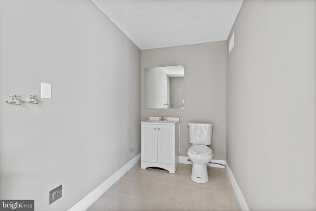 bathroom featuring tile patterned flooring, vanity, and toilet